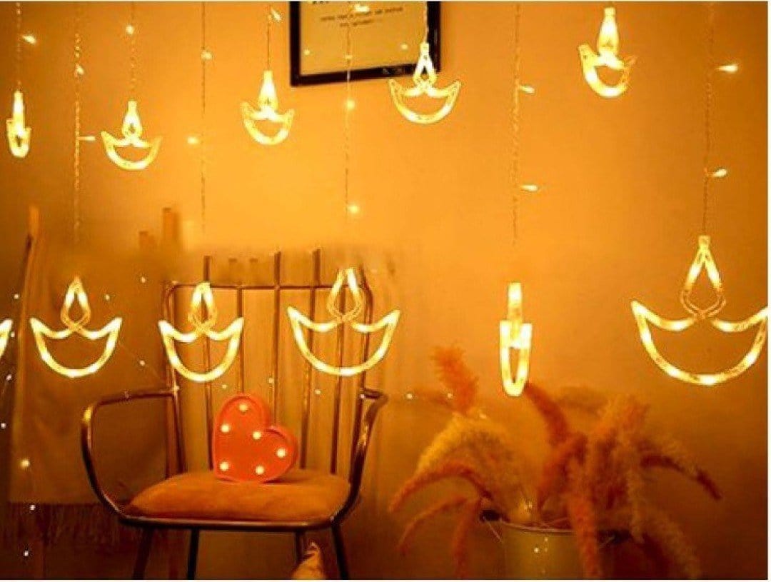 LAMANSH Rice light Yellow / Plastic / 6 feet LAMANSH® Diya Diwali Light Curtain, String Lights with 12 Hanging Diyas, 8 Flashing Modes - 2.5 Meter (1 Curtain) 138 LED , (6+6 Diyas )