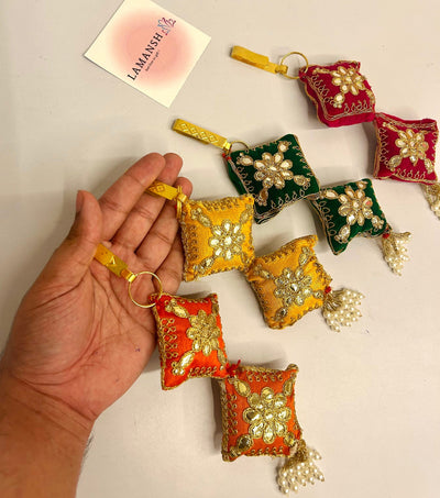 55 Rs each on buying 50+ pcs / WhatsApp at 8619550223 to order satka pins Designer fabric embroidered satka's keychains for ladies | haldi mehendi sangeet favors for bridesmaids in weddings